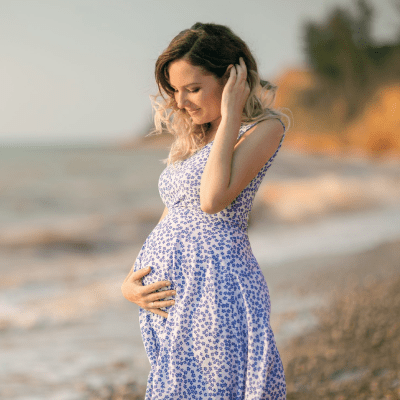 surrogate posing for photo on a beach