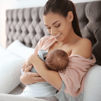mother holding baby from a successful surrogacy through Hatch