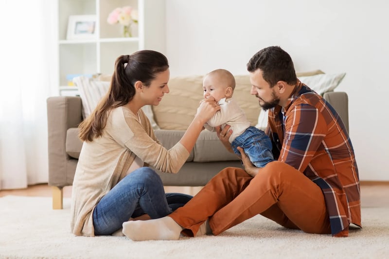 happy-family-with-baby-having-fun-at-home-PS9MHA5
