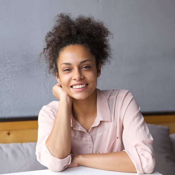 natural-young-woman-smiling-indoors-PZB2GEA-min cropped
