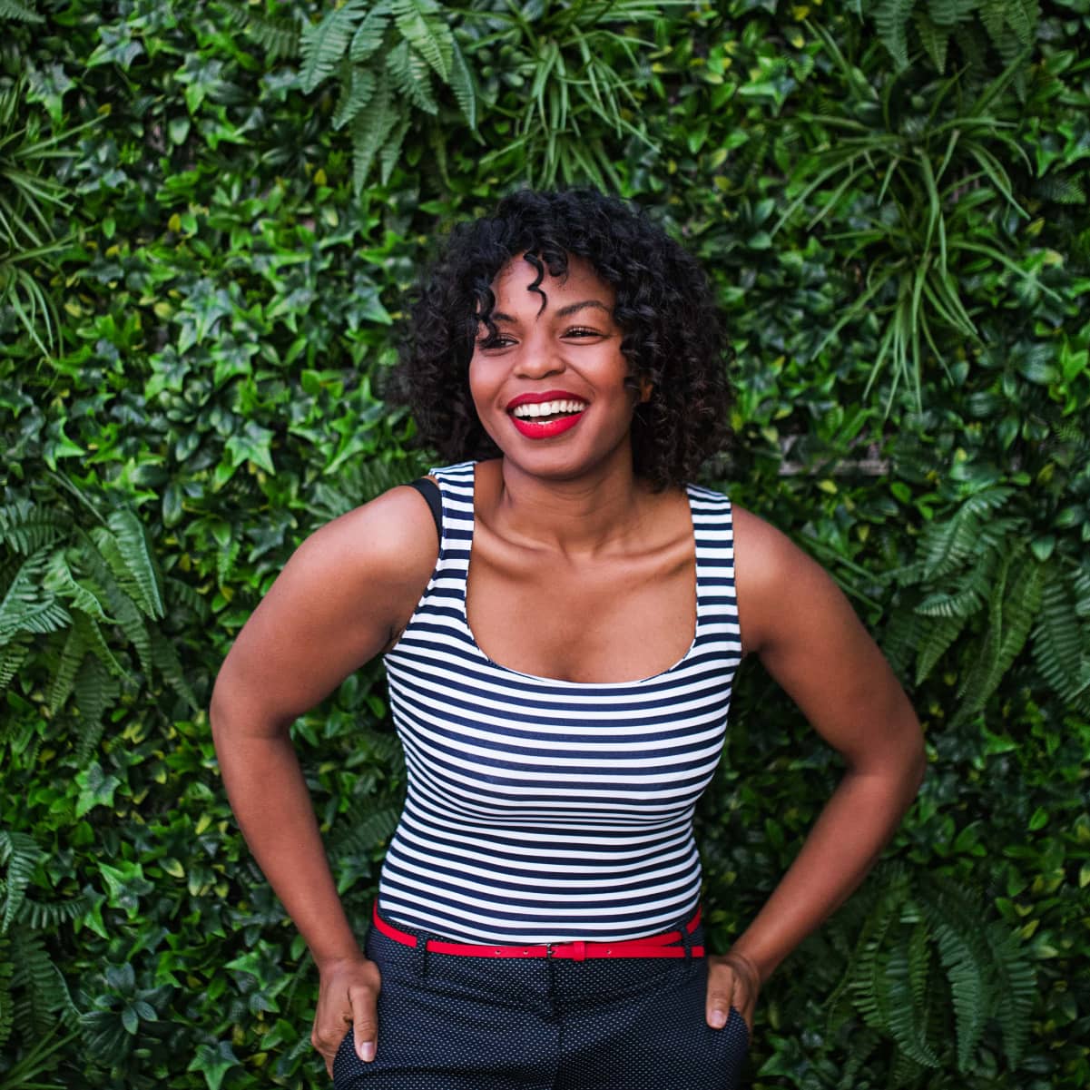 a-portrait-of-a-black-woman-standing-against-green-QA2G5RN-min cropped