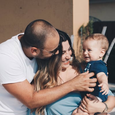 intended parents holding a baby