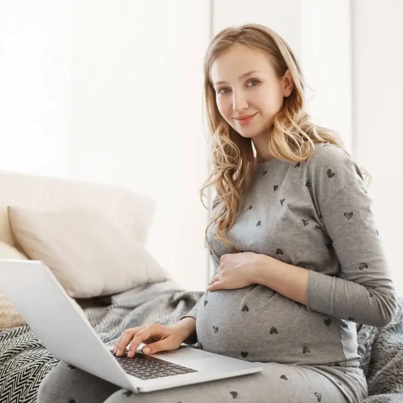 pregnant surrogate on computer