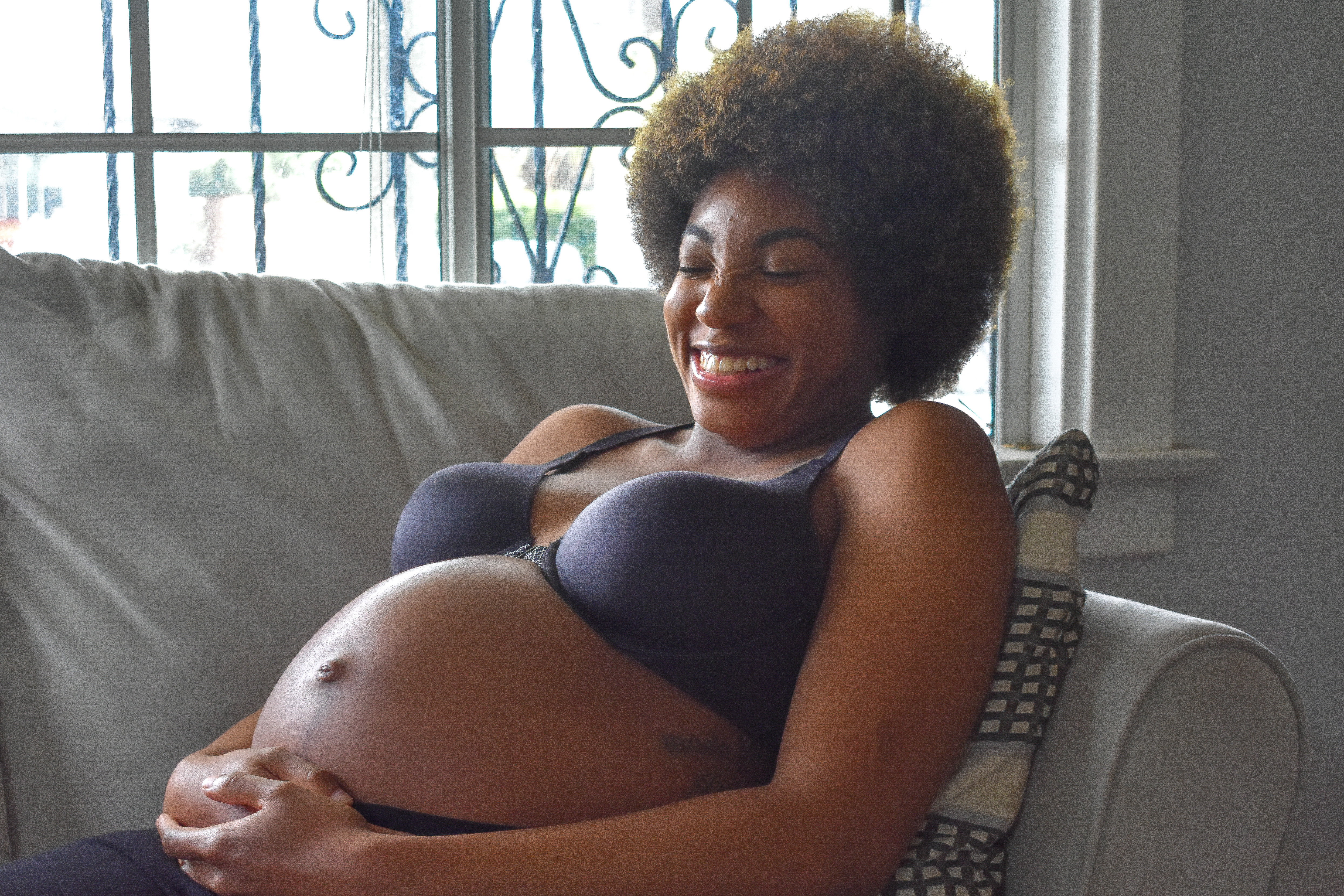 pregnant-woman-laughing-ANXRZFJ