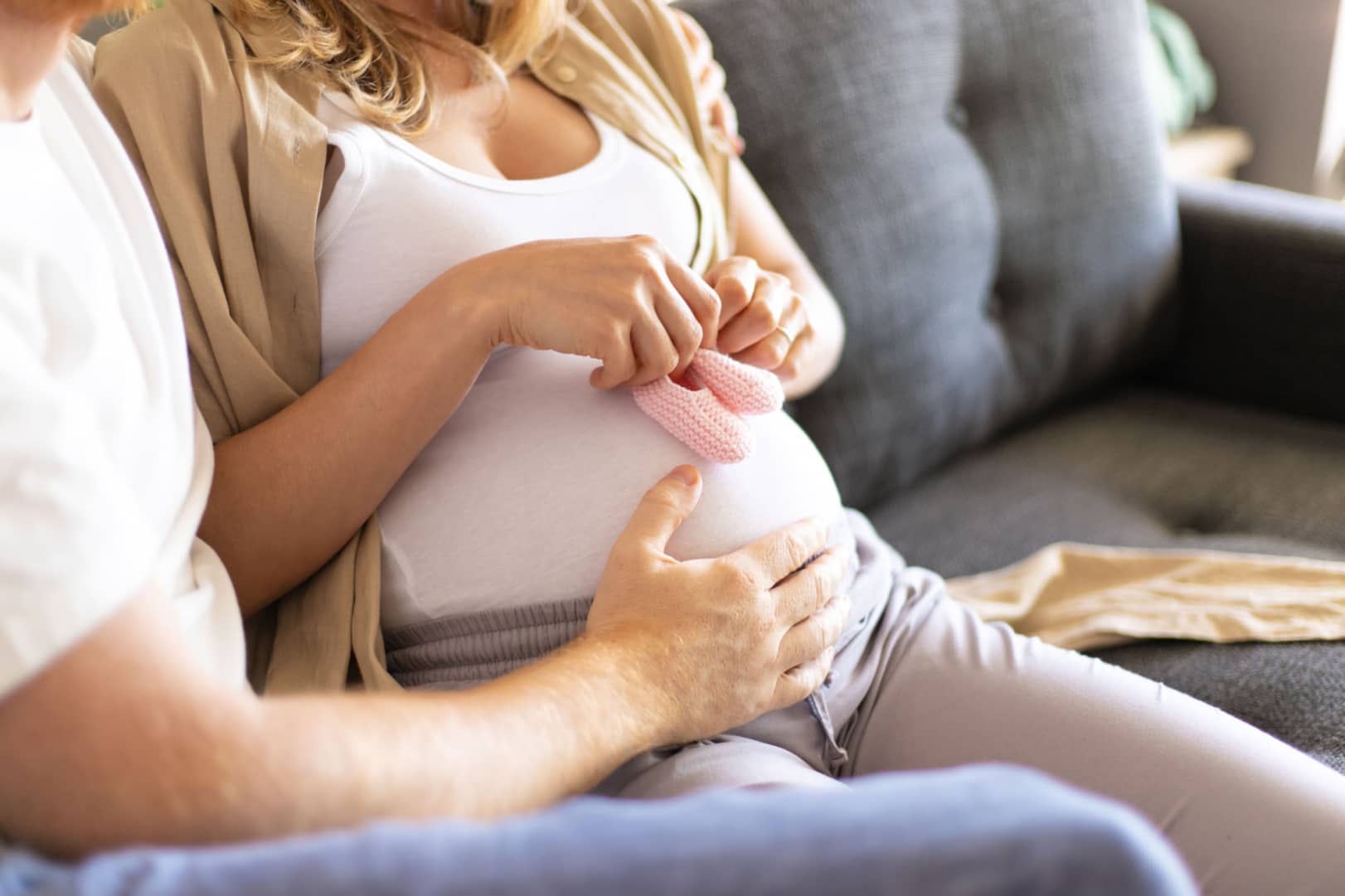 person holding surrogates baby belly