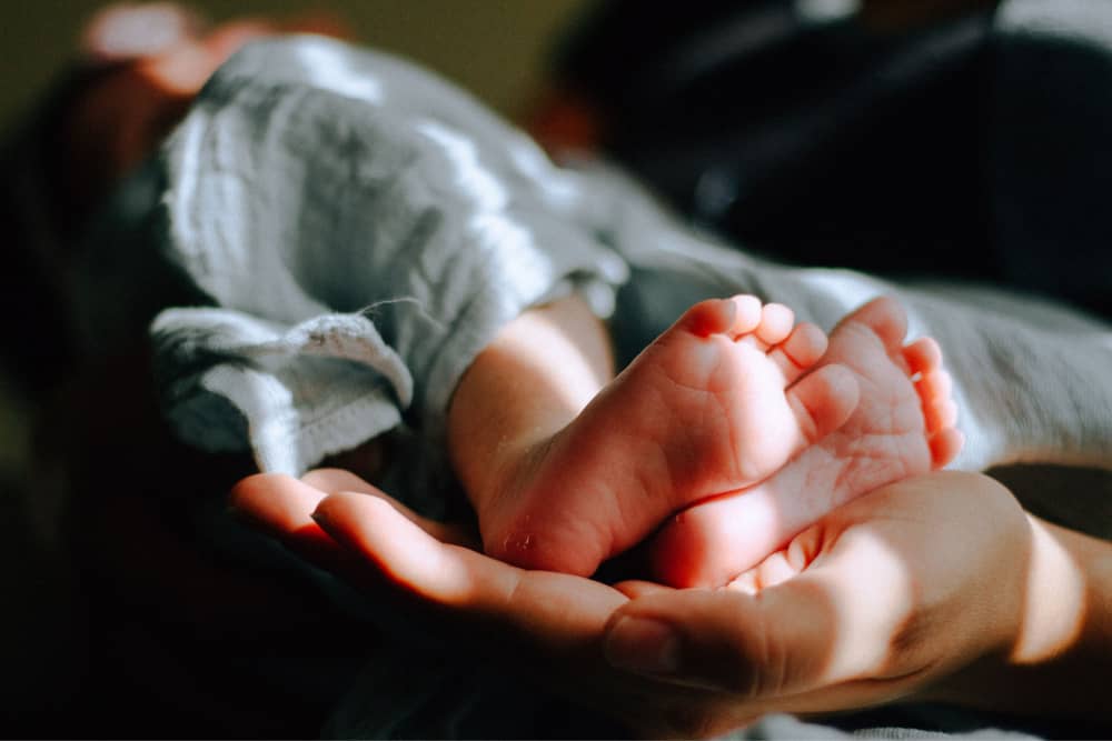 two baby feet | starting surrogacy journey